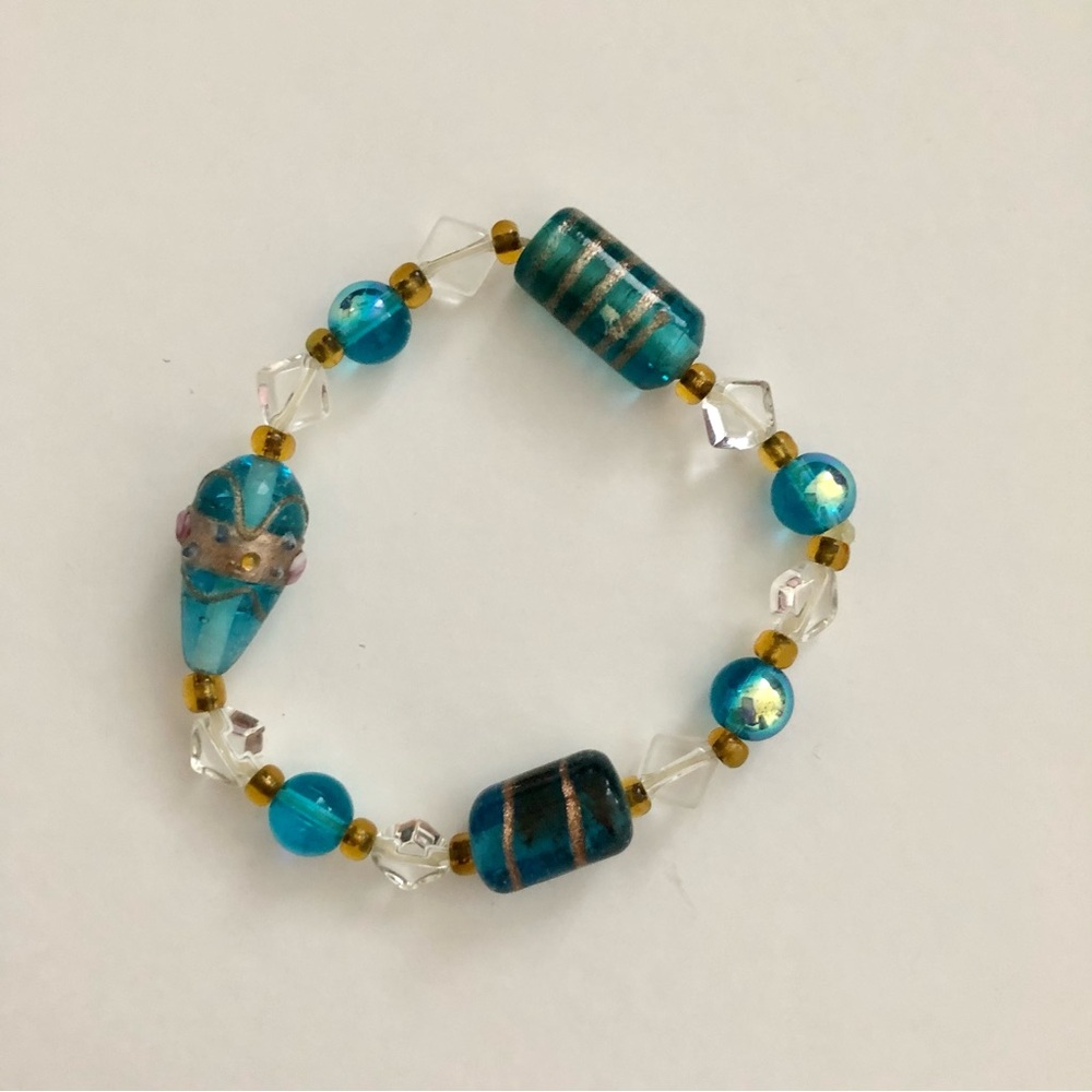 Blue and Gold Beaded Bracelet with Intricate Patterns and red bracelet